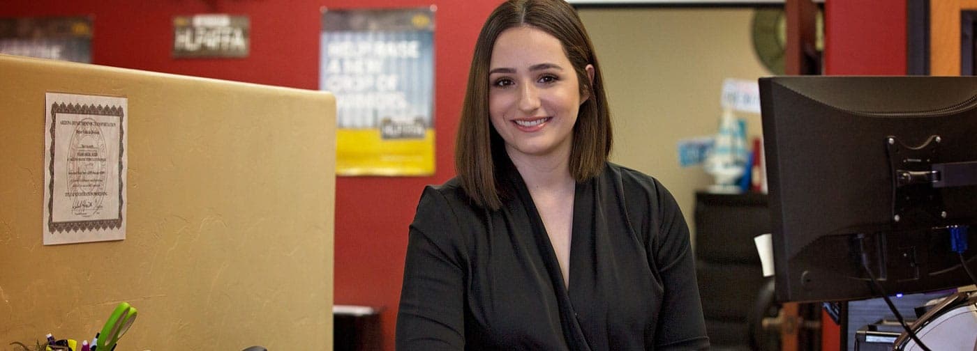 An Arizona Motor Vehicle Express team member at the front counter